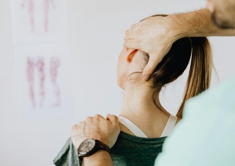 A therapist easing a patient's neck and shoulder tension
